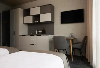 a bedroom with a bed and a table with chairs at Air Hotel in Karmėlava