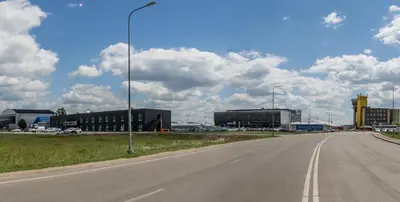 an empty highway with buildings and a street light at Air Hotel in Karmėlava