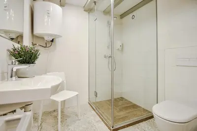 a bathroom with a shower and a toilet and a sink at Sodu15 Apartments in Vilnius
