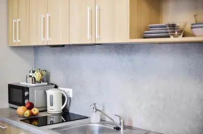 a kitchen with a sink and a microwave at Sodu15 Apartments in Vilnius