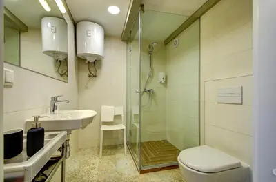 a bathroom with a shower and a toilet and a sink at Sodu15 Apartments in Vilnius