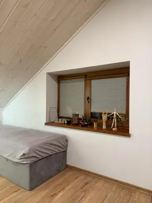 a bedroom with a bed and a window at Villa Midesta in Šiauliai