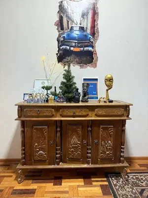 a wooden cabinet with a christmas tree on top of it at Villa Midesta in Šiauliai