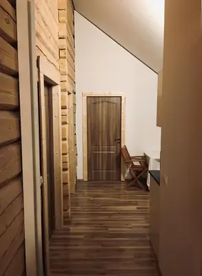 a hallway with a wooden floor and a door at Room in a Scandinavian Style House in Vilnius