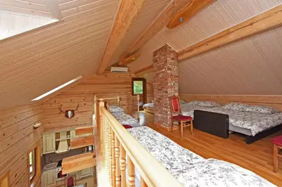 a room with two beds in a log cabin at Auksinis Ąžuolas in Avižieniai