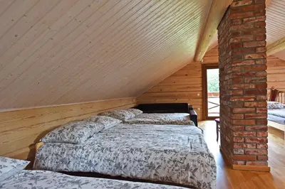 a bedroom with two beds in a attic at Auksinis Ąžuolas in Avižieniai
