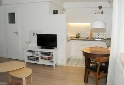 a kitchen with a table and a tv in a kitchen at Nijole ir Algimantas in Anykščiai