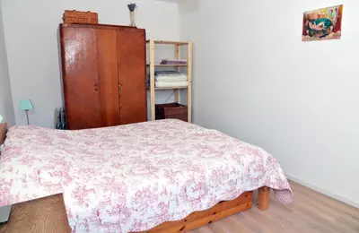 a bedroom with a bed and a wooden cabinet at Nijole ir Algimantas in Anykščiai