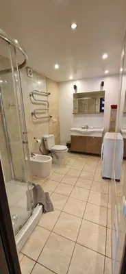 a large bathroom with two toilets and a shower at Jaukūs apartamentai Free parking in Vilnius