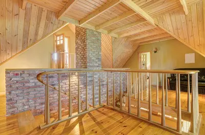 a staircase in a house with a brick wall at Country house Stirnamis in Mindūnai
