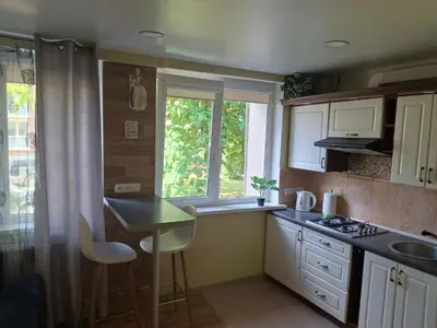 a small kitchen with a table and a window at Apartamentai Dana in Birštonas