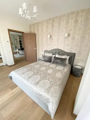 a bedroom with a bed and a wall at FoRest Apartments in Druskininkai