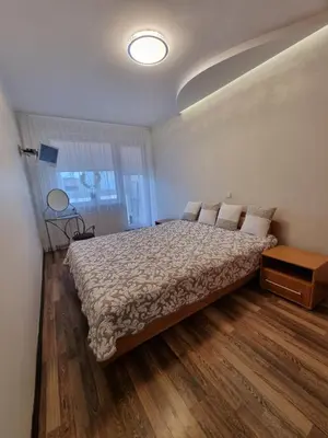 a bedroom with a bed and a window at Airida Forest Apartment in Druskininkai