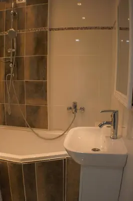 a bathroom with a sink and a shower at Siauliai Apartments - Ežero in Šiauliai