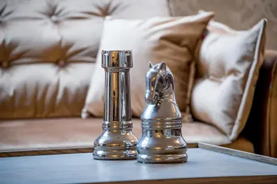 a silver horse saltire on a table with a couch at Hills Park Luxury Apartment in Vilnius