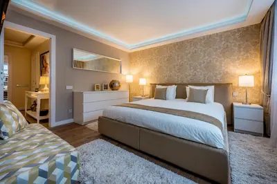 a large bedroom with a large bed and a couch at Hills Park Luxury Apartment in Vilnius