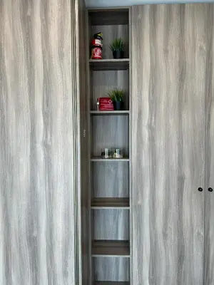 a book shelf with potted plants in a room at Your home - Spacious Apartment in City Center, with Balcony & Self Check-in in Vilnius