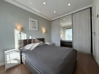 a bedroom with a large bed and a bathroom at Your home - Spacious Apartment in City Center, with Balcony & Self Check-in in Vilnius