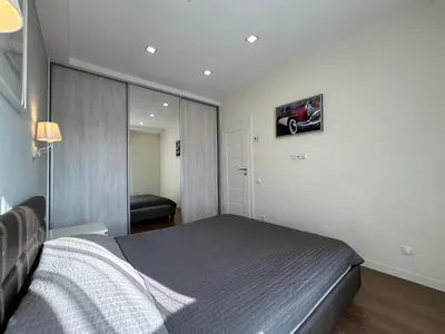 a bedroom with a bed and a mirror at Your home - Spacious Apartment in City Center, with Balcony & Self Check-in in Vilnius