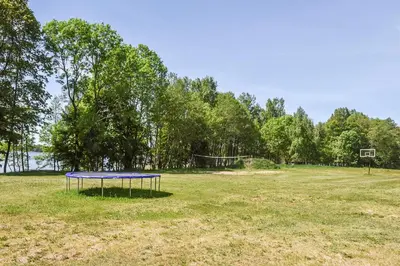 a blue table in the middle of a field at Duriu sodyba in Molėtai