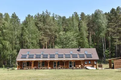 a large house with solar panels on the roof at Duriu sodyba in Molėtai