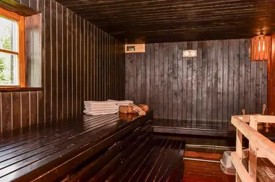 a wooden bench in a room with a window at Vila Loreta - namelis su pirtimi in Dūdorynė