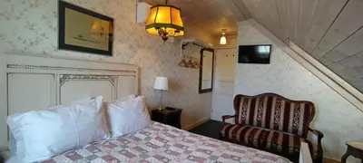 a hotel room with a bed and a chair at Labanoro troba in Labanoras