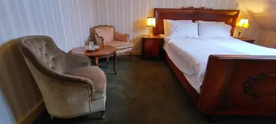 a hotel room with a bed and a table and chairs at Labanoro troba in Labanoras