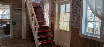 a spiral staircase in a room with windows at Labanoro troba in Labanoras