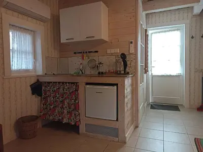 a kitchen with a counter and a window and a door at Labanoro troba in Labanoras