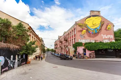 a building with a face painted on the side of it at Apartment Gabriele in Old Town Vilnius in Vilnius