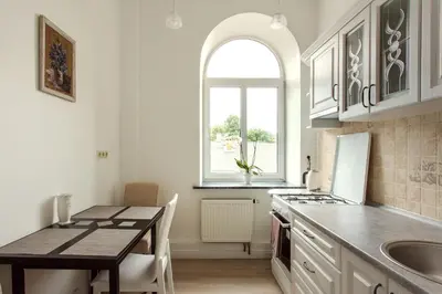 a kitchen with a table and a sink and a counter top at Apartment Gabriele in Old Town Vilnius in Vilnius