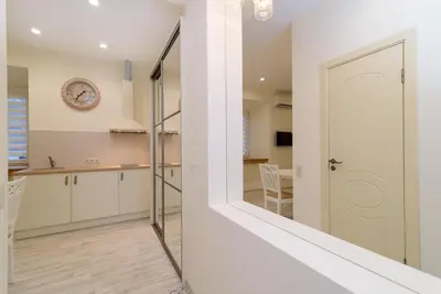 a kitchen with white cabinets and a white door at M.K. Čiurlionis 7 in Vilnius