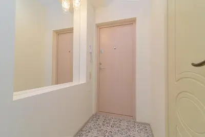 a hallway with a door and a mirror at M.K. Čiurlionis 7 in Vilnius
