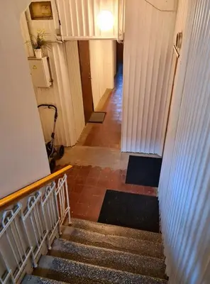 a long hallway with stairs in a building at M.K. Čiurlionis 7 in Vilnius