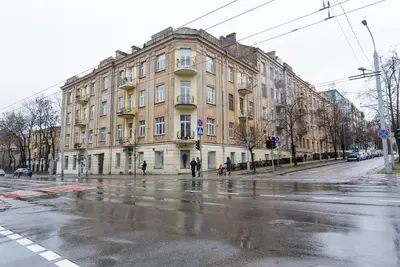 an empty street with a large building on the corner at M.K. Čiurlionis 7 in Vilnius