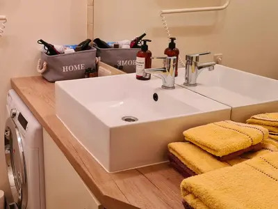 a bathroom with a white sink in a room at M.K. Čiurlionis 7 in Vilnius