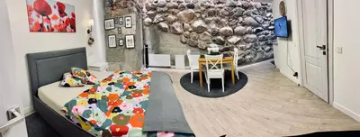 a bedroom with a bed and a dining room at Six Apartment Simona in Vilnius
