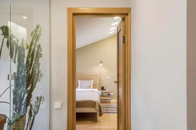 a door leading into a bedroom with a bed at Maironis apartment 2 in Kaunas