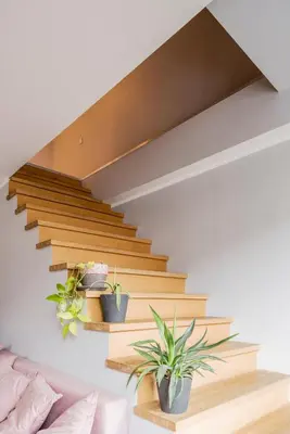 a staircase with potted plants on the wall at Maironis apartment 2 in Kaunas