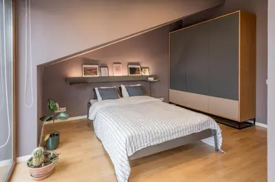 a bedroom with a bed with a large headboard at Maironis apartment 2 in Kaunas