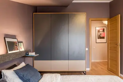 a bedroom with a large glass cabinet next to a bed at Maironis apartment 2 in Kaunas