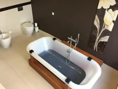 a bath tub in a bathroom with a toilet at Panorama Apartment in Druskininkai