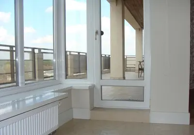 a white room with windows and a balcony at Panorama Apartment in Druskininkai
