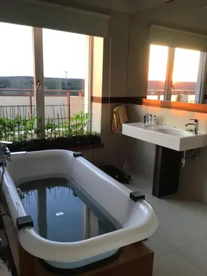 a bathroom with a bath tub and a sink at Panorama Apartment in Druskininkai