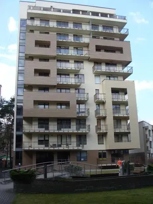a tall building with balconies on the side of it at Panorama Apartment in Druskininkai