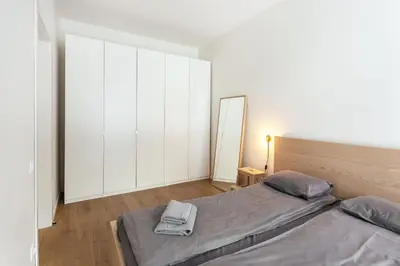 a bedroom with a bed and a mirror at #stayhere - Modern Designer 1BDR Apartment in Artistic District in Vilnius