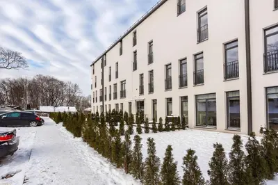 a building with christmas trees in front of it at #stayhere - Modern Designer 1BDR Apartment in Artistic District in Vilnius