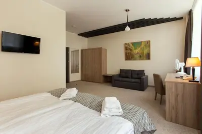 a bedroom with a bed and a desk and a couch at Old Town Trio in Vilnius