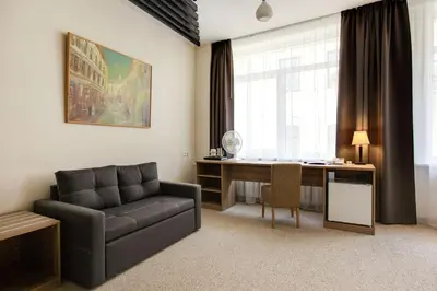 a living room with a couch and a desk at Old Town Trio in Vilnius